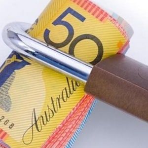 $50 bank note wrapped in a padlock