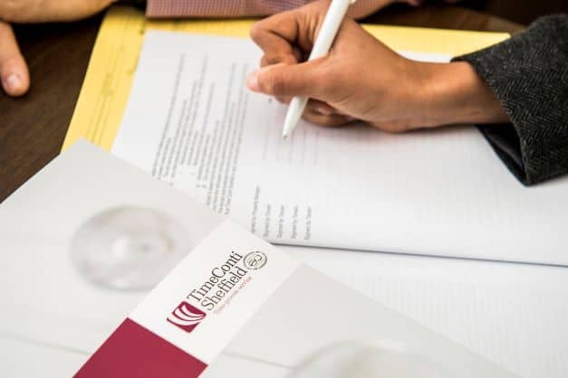 person signing a contract