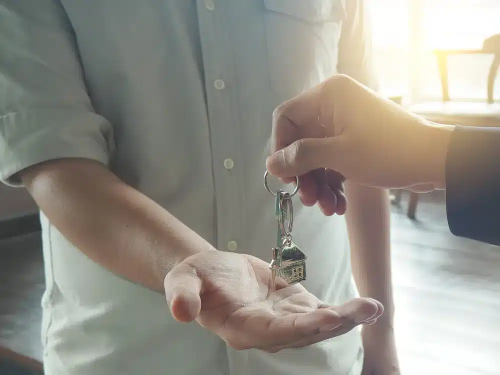 person being handed house keys