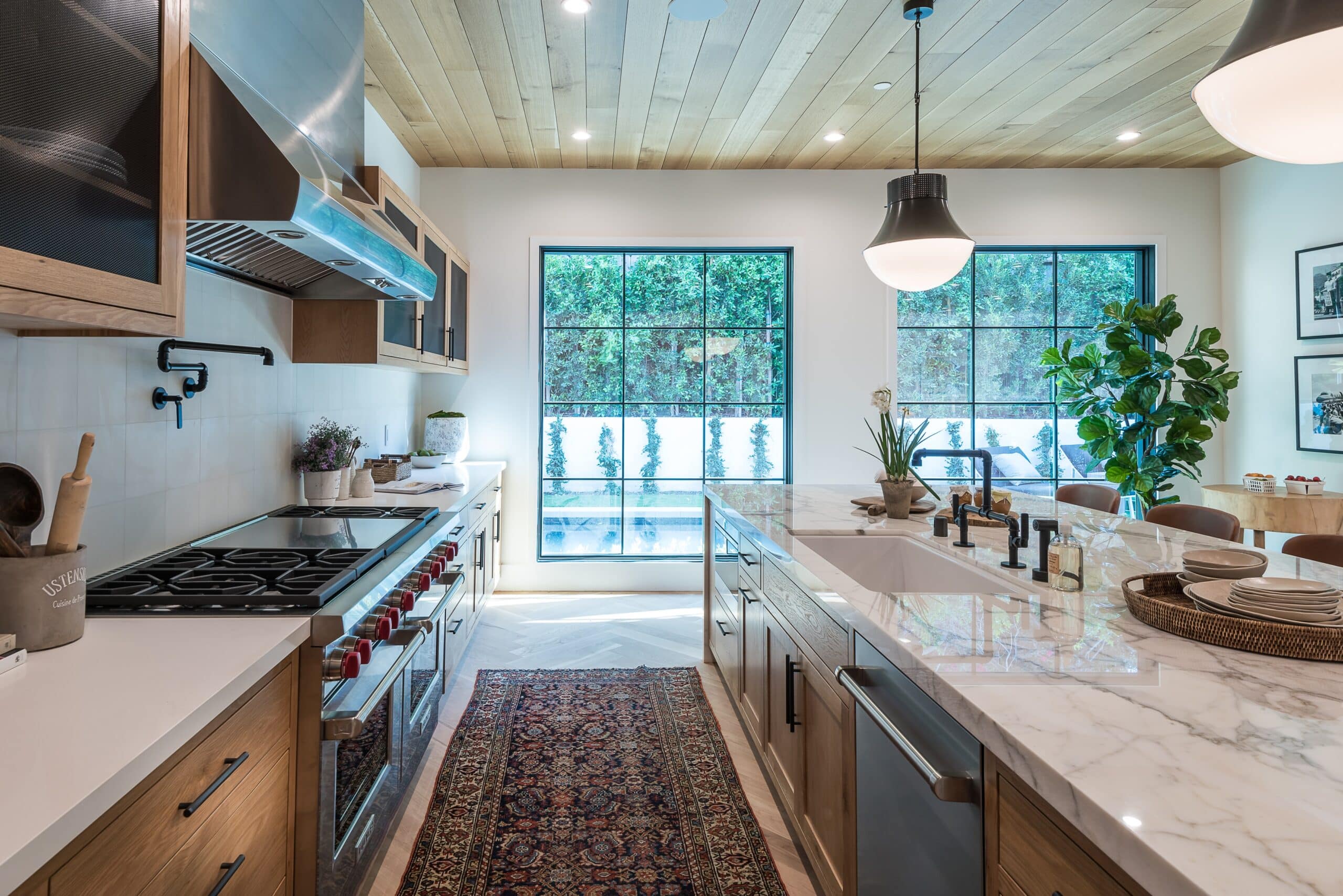 a modern kitchen with lots of bench space and a white marble island