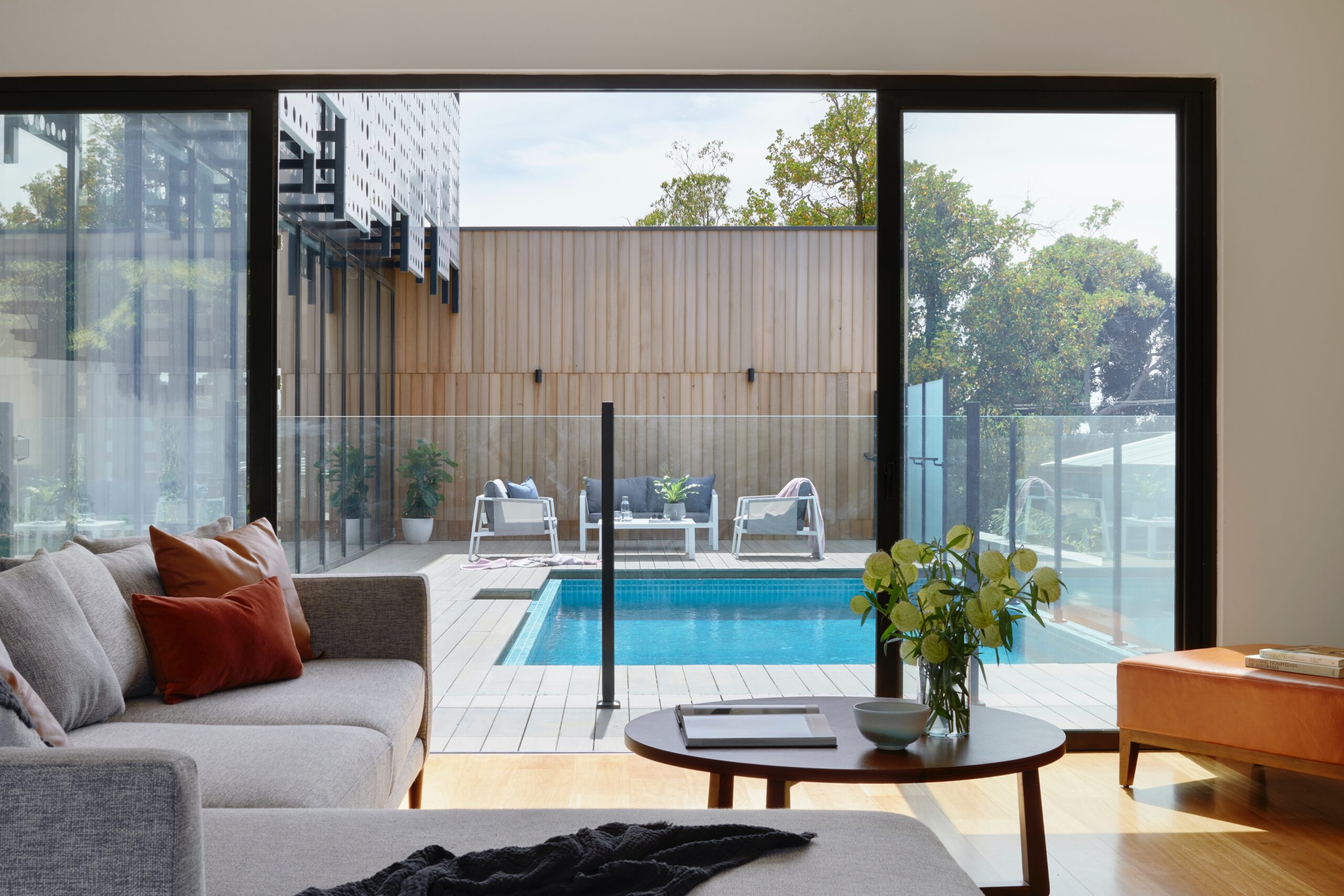 modern living room interior with views of pool outside