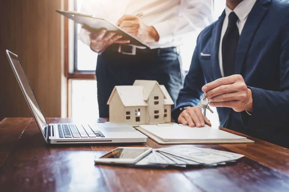person handing over house keys