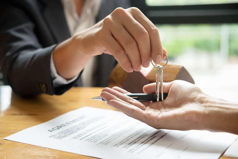 person being handed keys